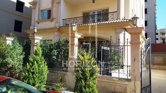 Ground floor with garden for sale in front of AUC New Cairo